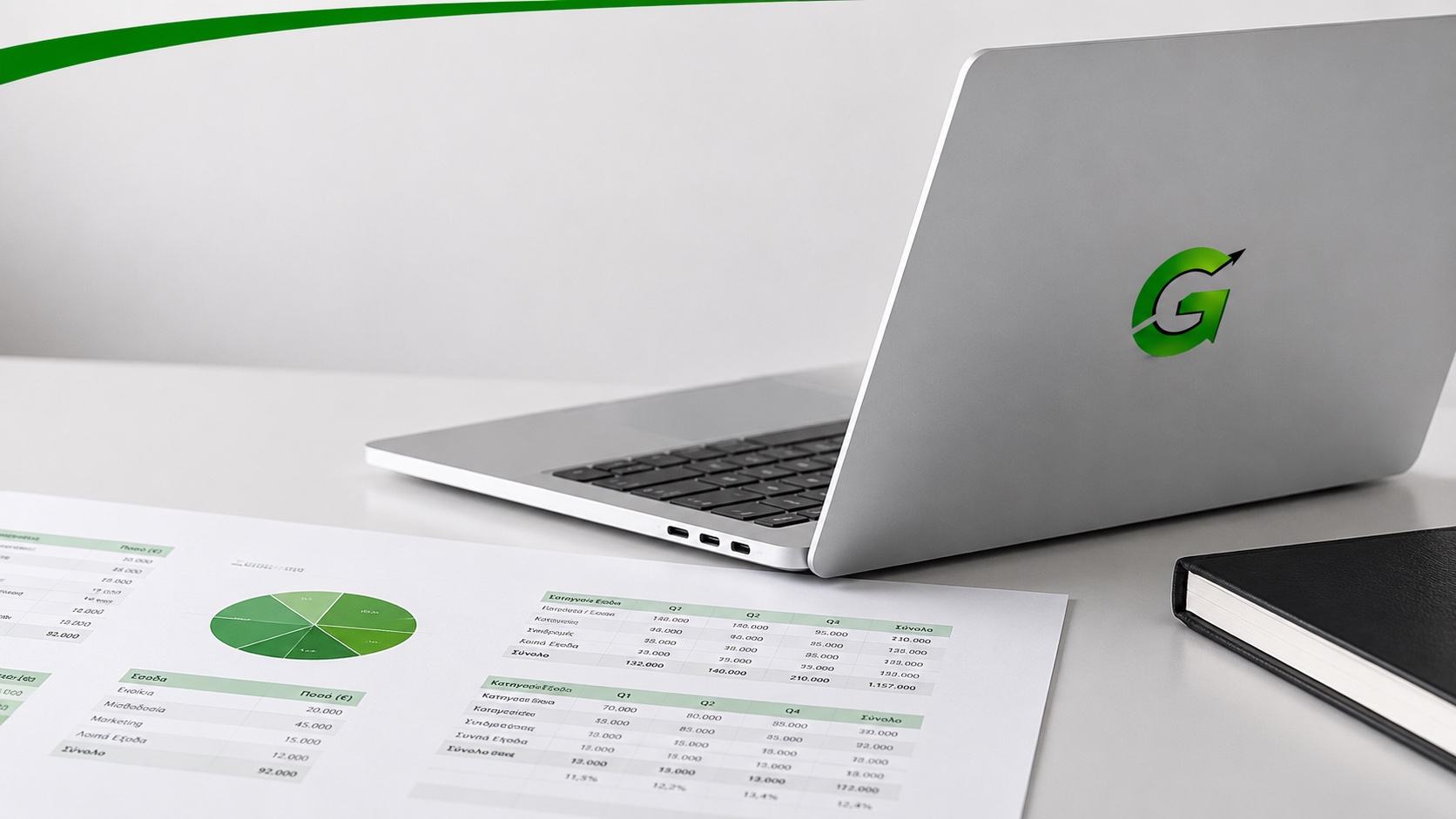 Green Ledger office desk with laptop and financial reports
